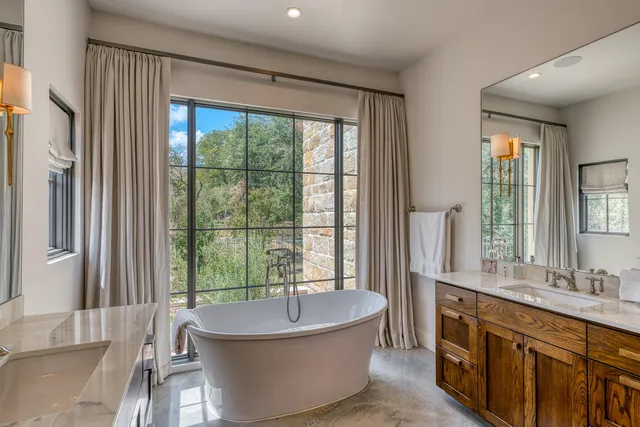 a spacious bathroom with a large tub and sink