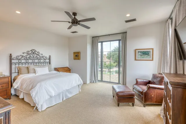 a spacious bedroom with a bed and a couch