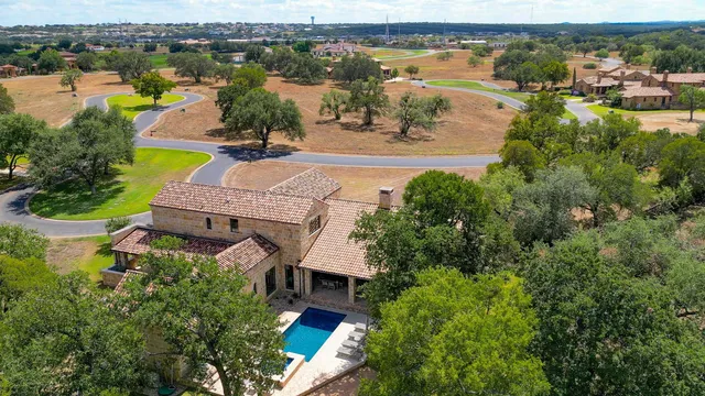an aerial view of a house with a lake view
