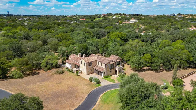 an aerial view of a house with a yard