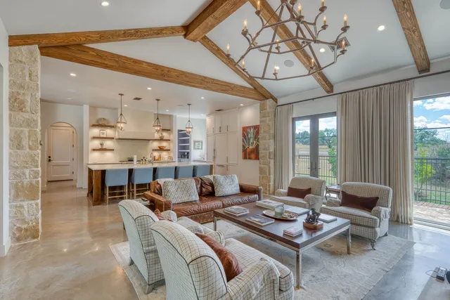 a living room with furniture a rug and a chandelier