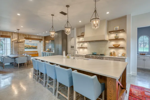 a large kitchen with a table and chairs