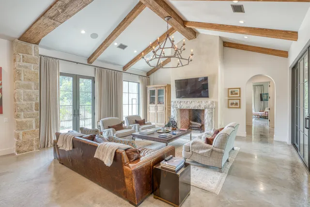 a living room with fireplace furniture and a flat screen tv