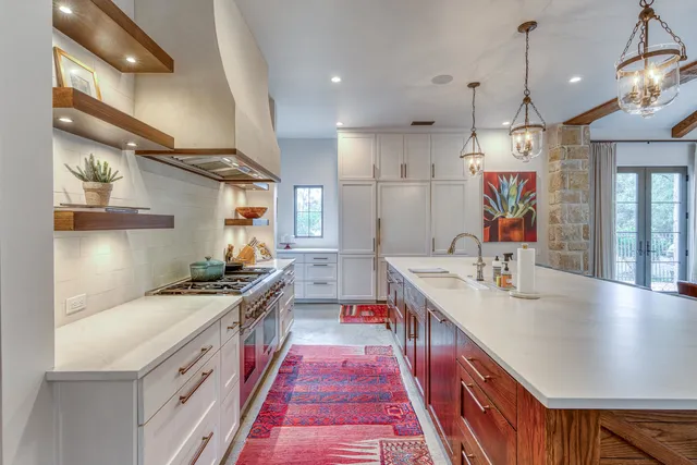 a kitchen with stainless steel appliances granite countertop a sink and a stove