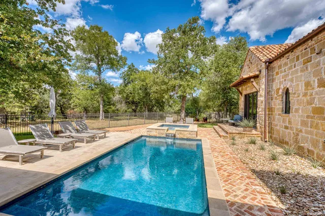 a view of a swimming pool with a lounge chairs