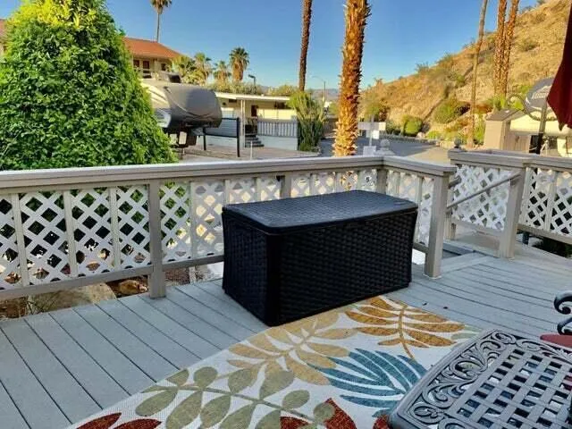 a living room with furniture a fireplace and potted plants