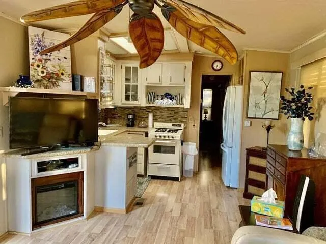 a kitchen with granite countertop a stove and a sink
