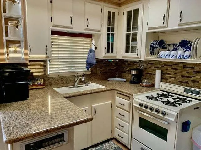 a view of a hallway with wooden floor and a bathroom