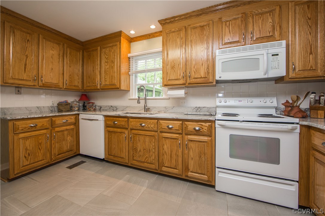 2701 East Brigstock Road Midlothian, VA 23113 - Photo 12 of 50 a kitchen with granite countertop cabinets stainless steel appliances and a sink