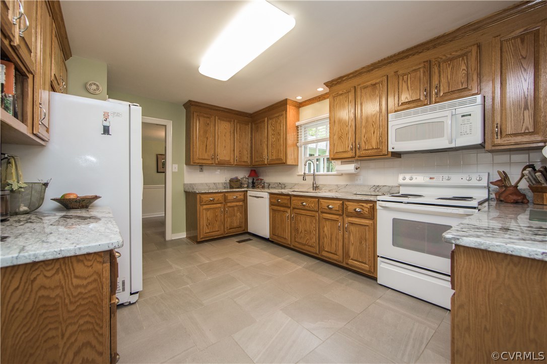 2701 East Brigstock Road Midlothian, VA 23113 - Photo 13 of 50 a kitchen with stainless steel appliances granite countertop a stove a sink dishwasher and a refrigerator