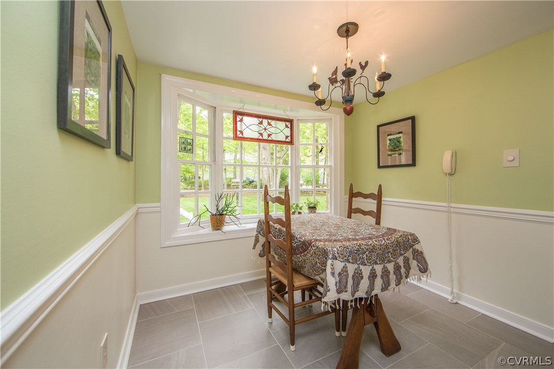 2701 East Brigstock Road Midlothian, VA 23113 - Photo 16 of 50 a bedroom with a bed and a chandelier
