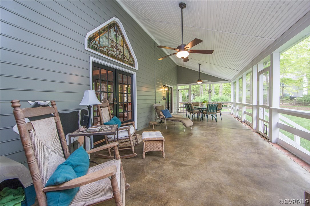 2701 East Brigstock Road Midlothian, VA 23113 - Photo 24 of 50 a view of a livingroom with furniture large windows wooden floor and a chandelier