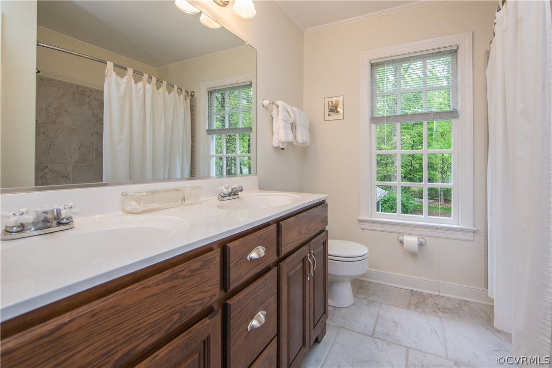 2701 East Brigstock Road Midlothian, VA 23113 - Photo 38 of 50 a bathroom with a double vanity sink toilet and a mirror