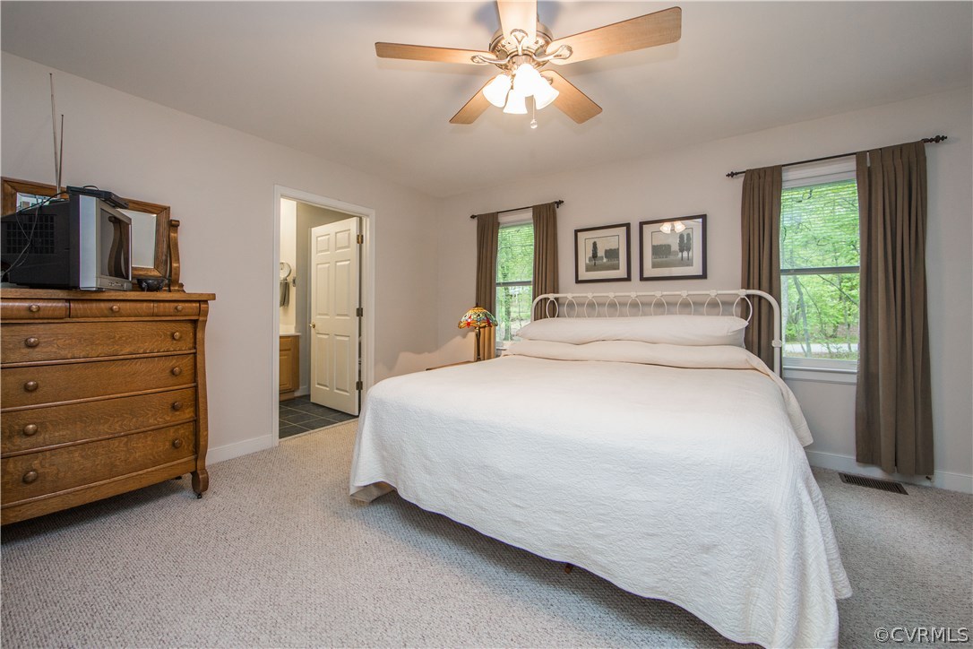 2701 East Brigstock Road Midlothian, VA 23113 - Photo 42 of 50 a bedroom with a bed and a flat tv screen on dresser