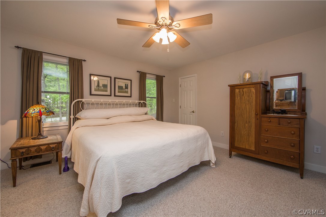 2701 East Brigstock Road Midlothian, VA 23113 - Photo 43 of 50 a bedroom with a bed and a chandelier