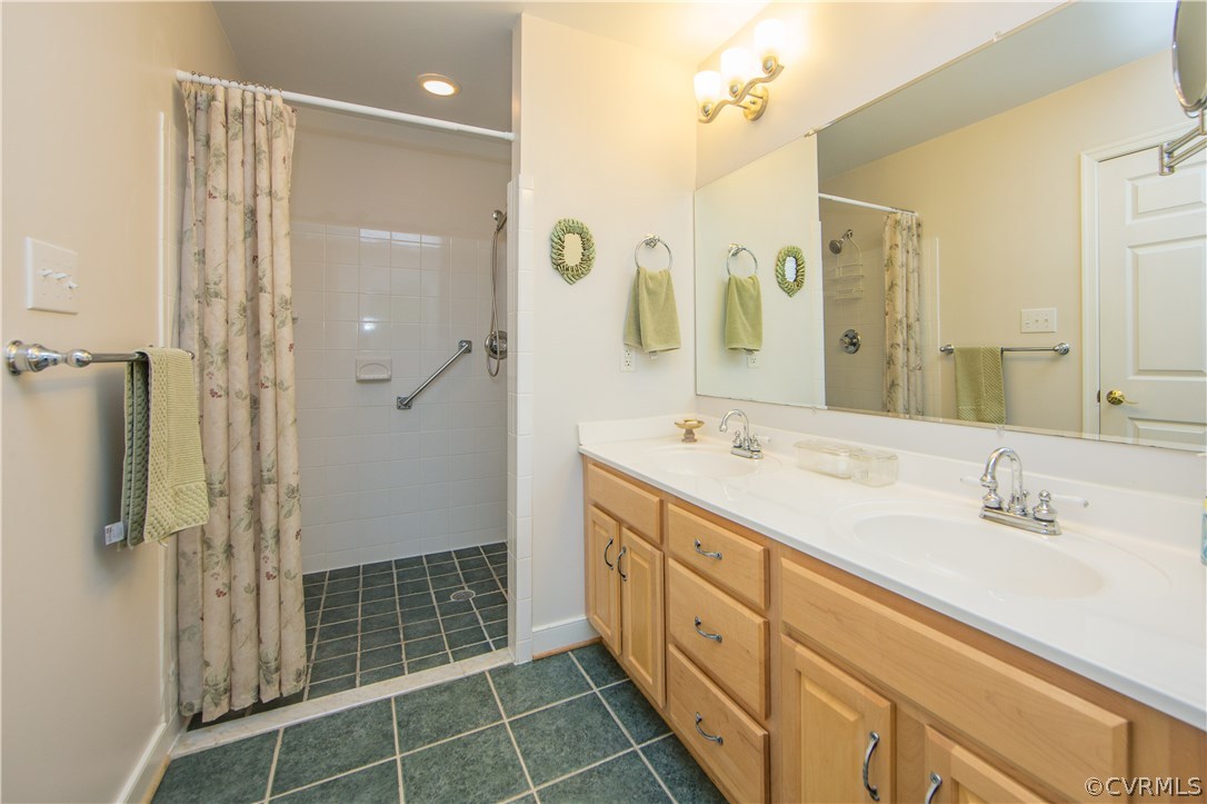2701 East Brigstock Road Midlothian, VA 23113 - Photo 44 of 50 a spacious bathroom with a shower sink and mirror