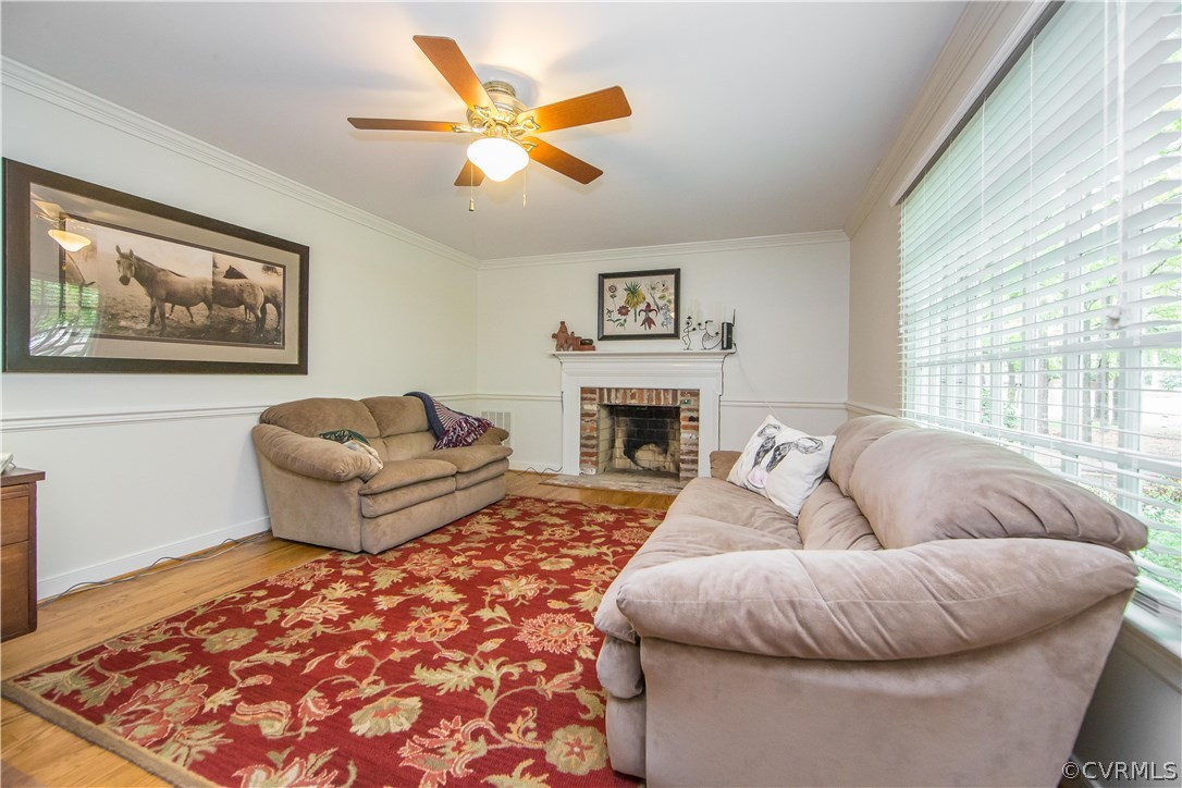 2701 East Brigstock Road Midlothian, VA 23113 - Photo 46 of 50 a living room with furniture and a fireplace