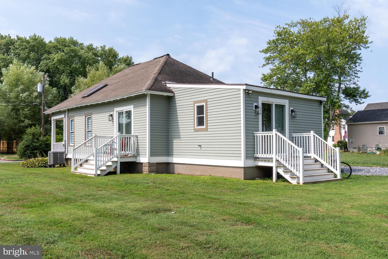 207 Dodson Avenue St. Michaels, MD 21663 - Photo 28 of 44 a front view of a house with a yard garden and deck
