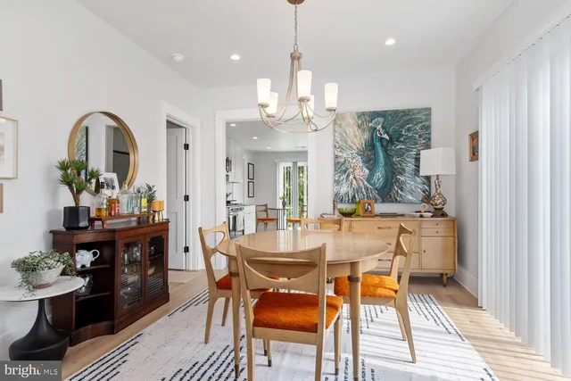 a view of a dining room with furniture and a chandelier