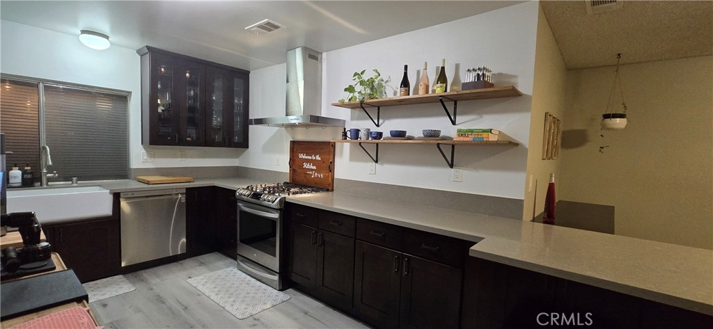 6830 Astoria Drive Riverside, CA 92503 - Photo 9 of 23 a kitchen with stainless steel appliances a sink and stove