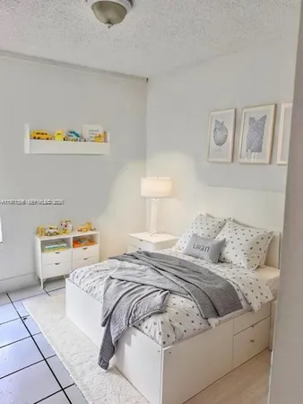 a bedroom with a bed and couch