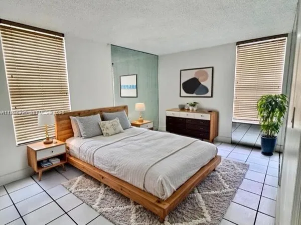 a bedroom with a bed and a potted plant