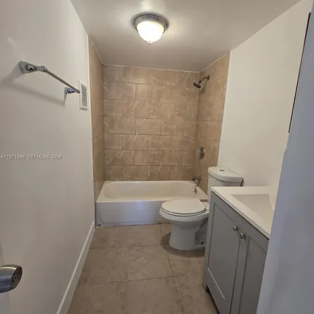 a bathroom with a toilet a sink and a bathtub