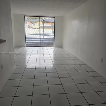 a view of an empty room and a window