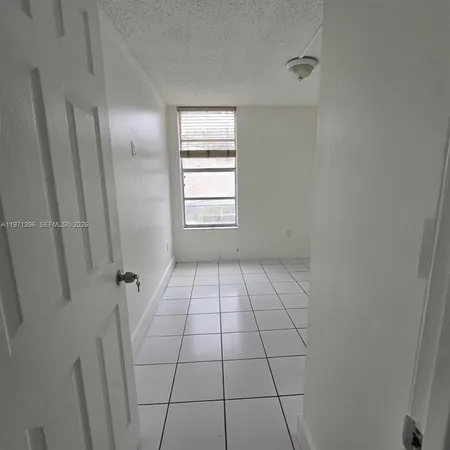 a view of an empty room and a window