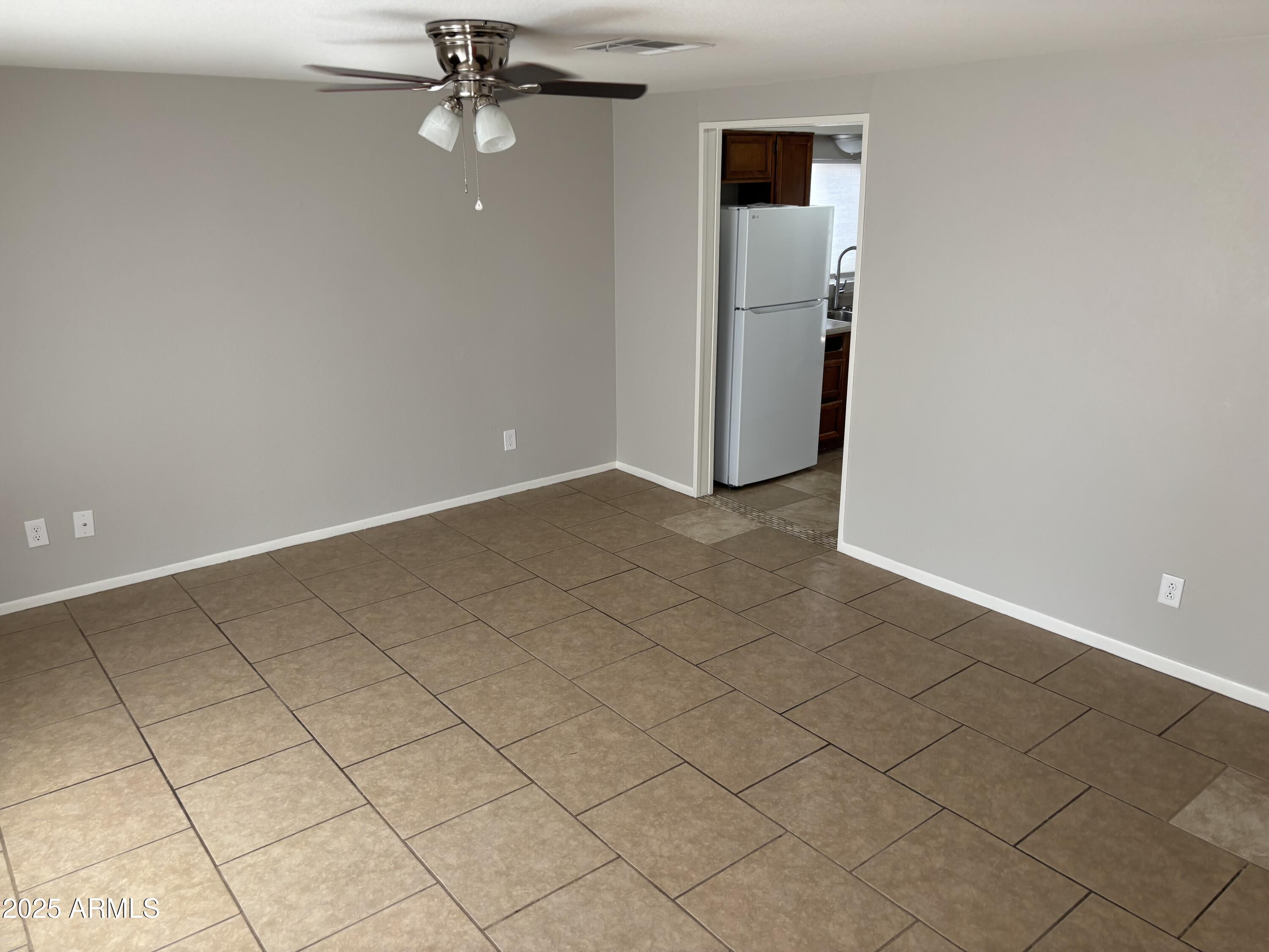 148 South 54th Street, Unit A Mesa, AZ 85206 - Photo 2 of 11 an empty room with windows