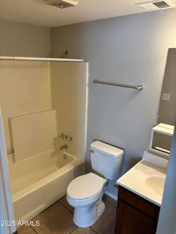 a bathroom with a toilet a sink and bathtub