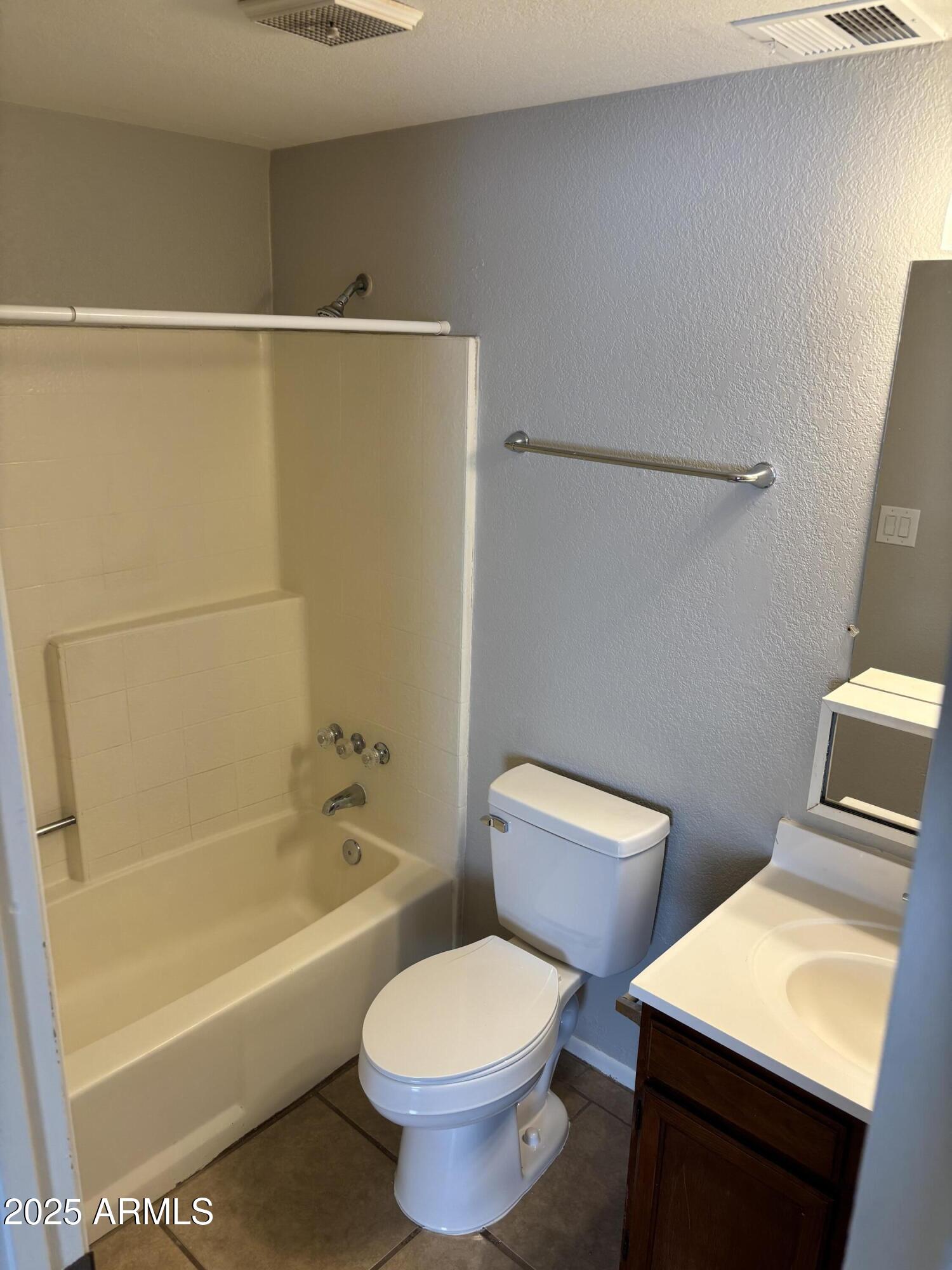 148 South 54th Street, Unit A Mesa, AZ 85206 - Photo 5 of 11 a bathroom with a toilet a sink and bathtub