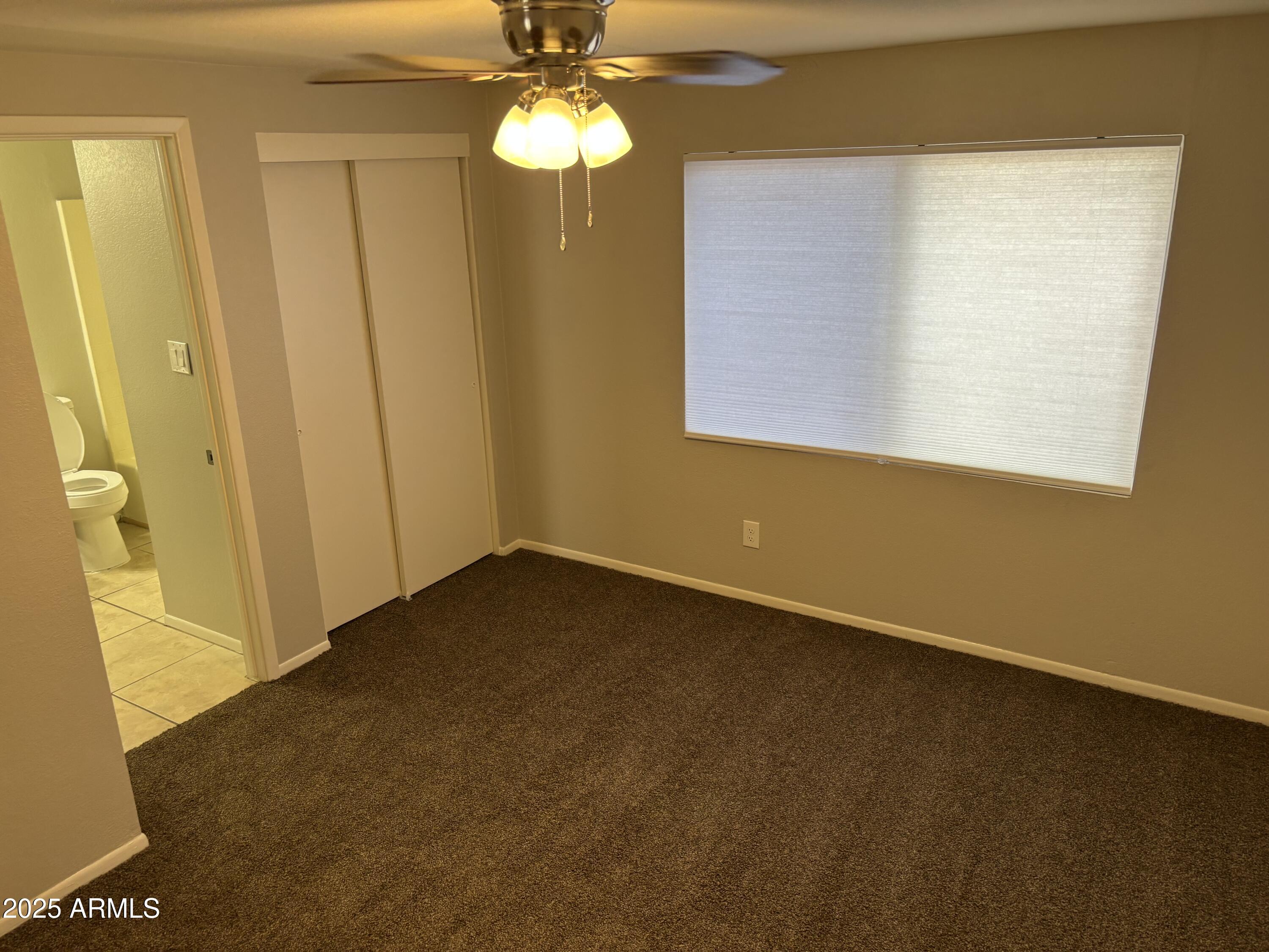 148 South 54th Street, Unit A Mesa, AZ 85206 - Photo 8 of 11 a view of an empty room with a window