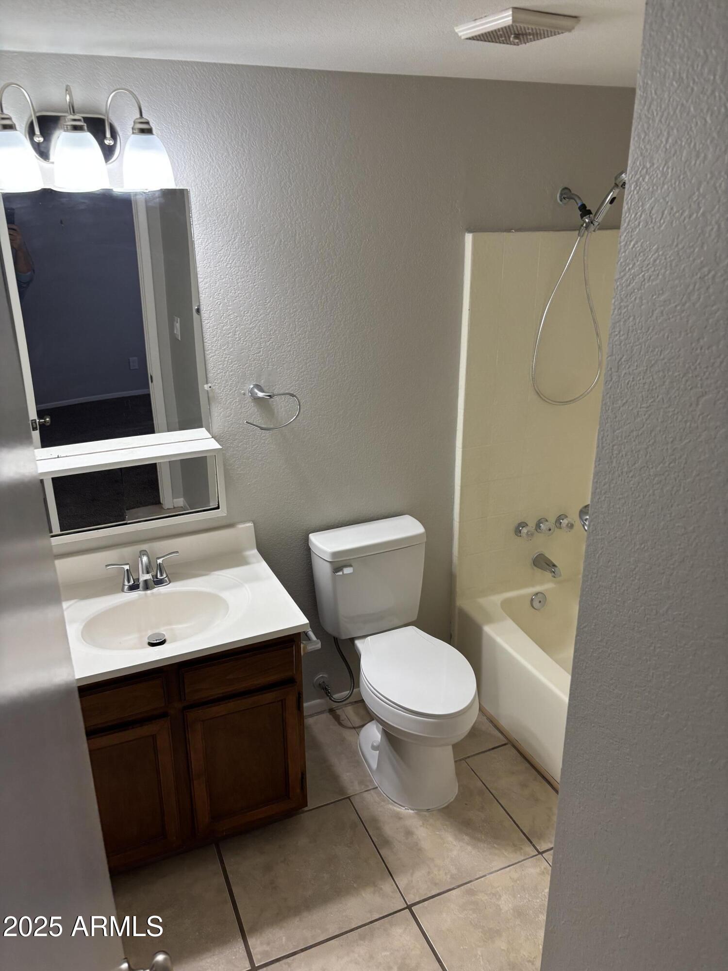 148 South 54th Street, Unit A Mesa, AZ 85206 - Photo 9 of 11 a bathroom with a toilet sink and mirror