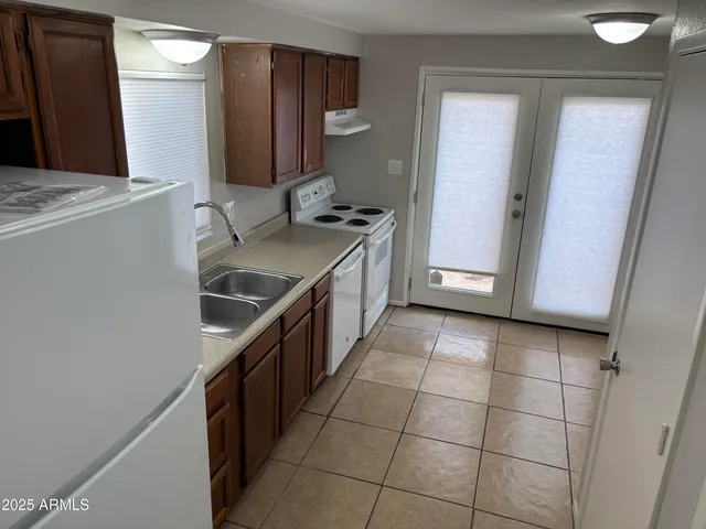 a kitchen with stainless steel appliances a sink stove and cabinets