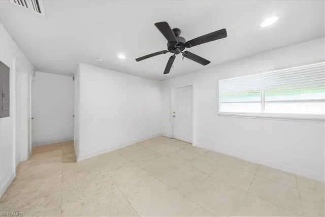 a view of room with a ceiling fan and window