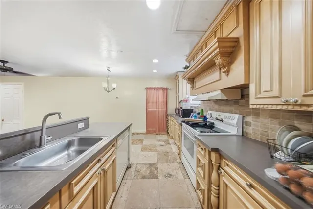 a kitchen with granite countertop cabinets stainless steel appliances and a sink