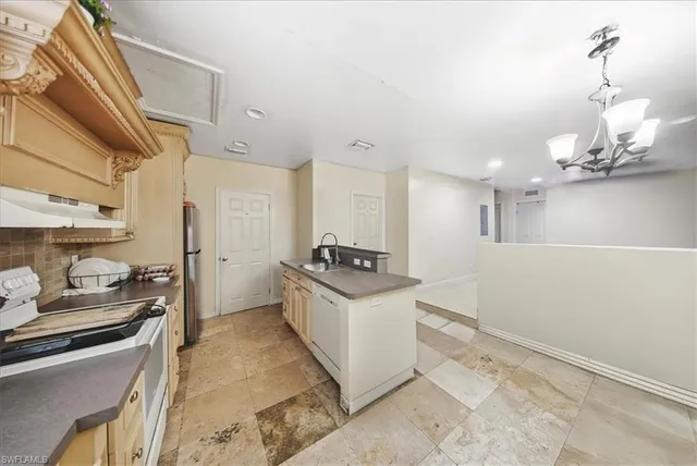 a open kitchen with a sink and refrigerator