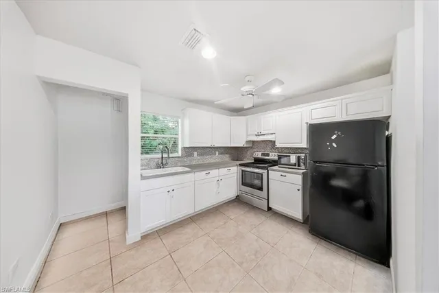 a bathroom with a sink toilet vanity and tub