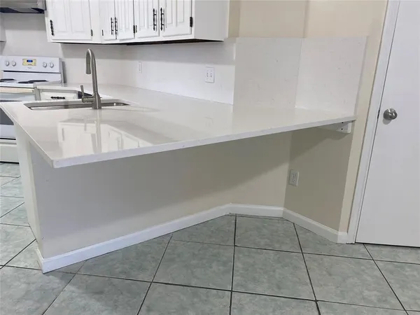 a kitchen with a sink and cabinets