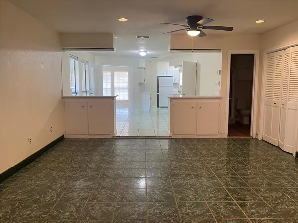 a view of kitchen with a sink and a refrigerator