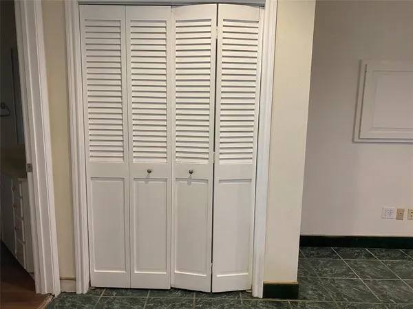 a view of a room with a chair and a window