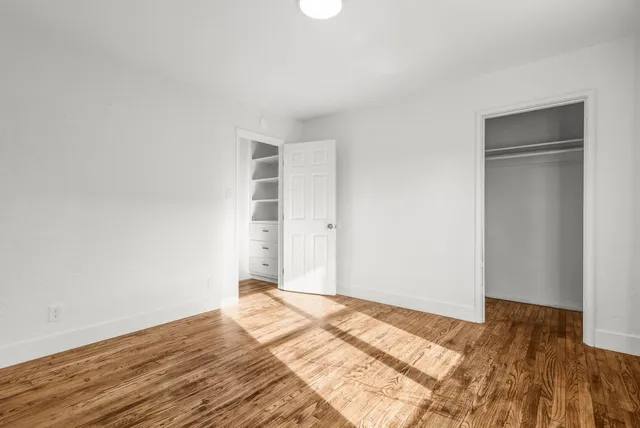 a view of a room with wooden floor and closet