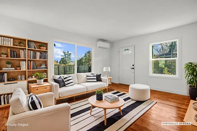 a living room with furniture and a book shelf