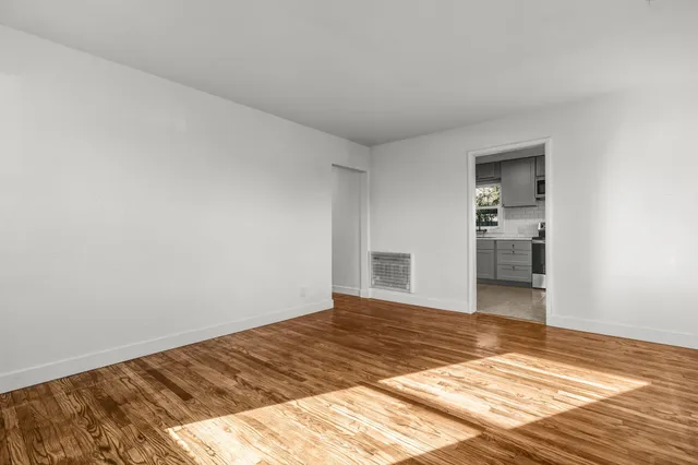 a view of a bedroom with wooden floor and bedroom
