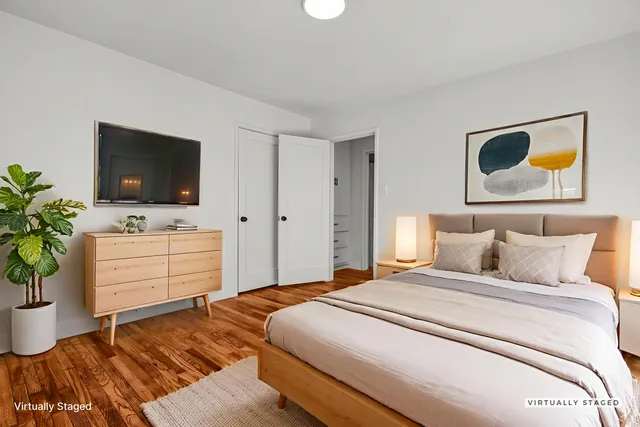 a bedroom with a bed and flat screen tv