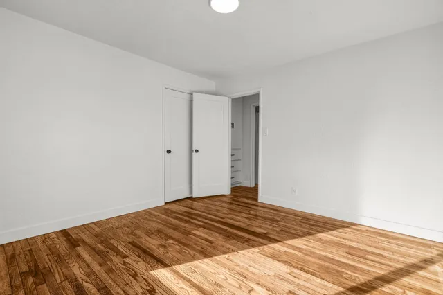 a bedroom with a bed and a rug