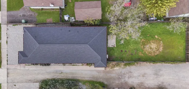 an aerial view of a house with a yard