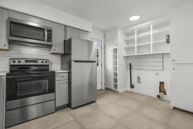 a kitchen with a refrigerator stove and microwave