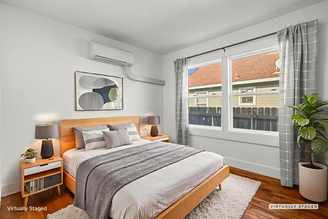 a bedroom with a bed and a potted plant